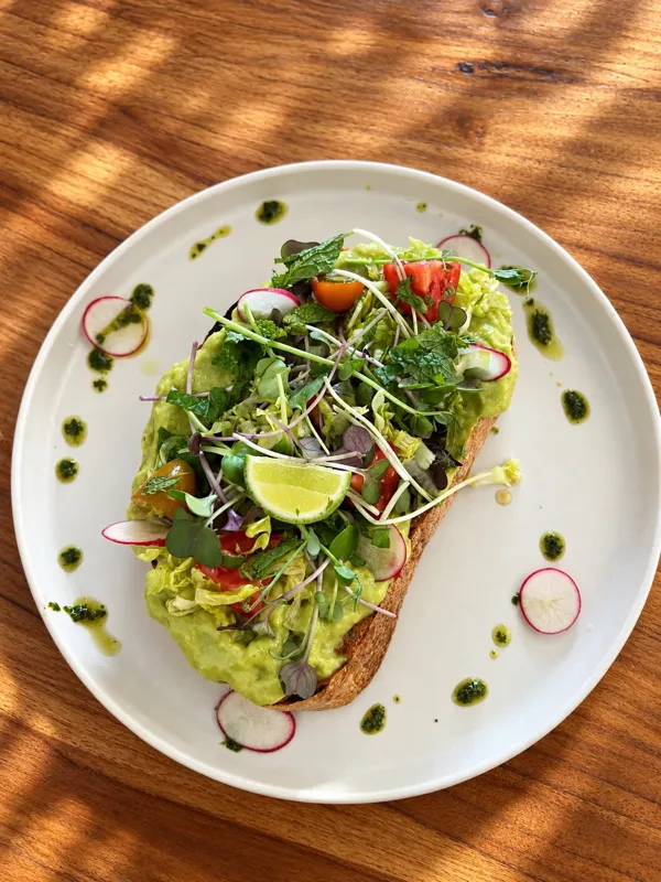 Avocado sourdough with fresh greens and lime at Luana