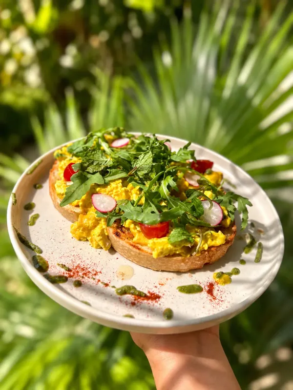 Scrambled tofu sourdough with fresh herbs at Luana