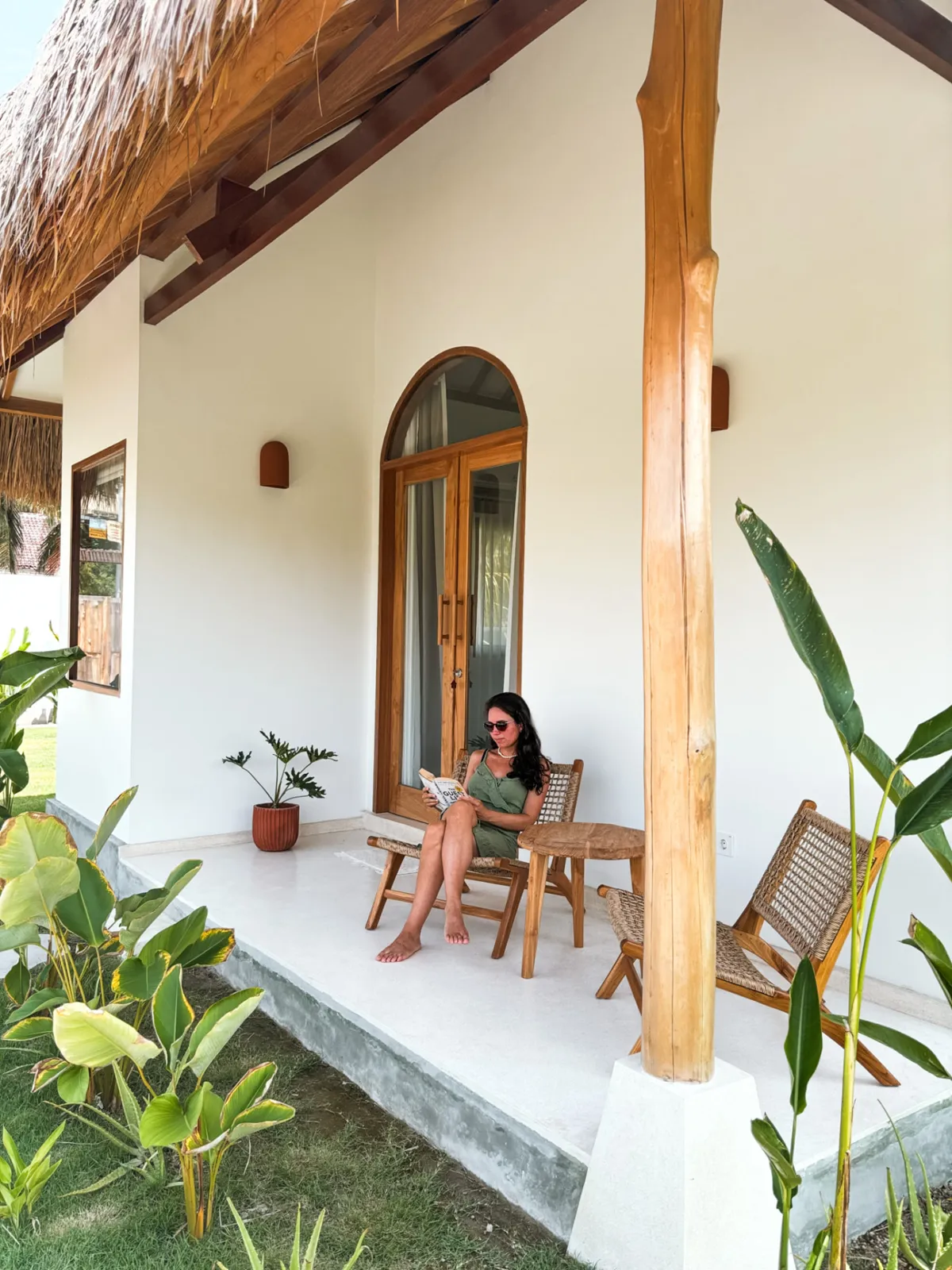 Guest reading on the private terrace of the Private Bungalow at Luana Lombok
