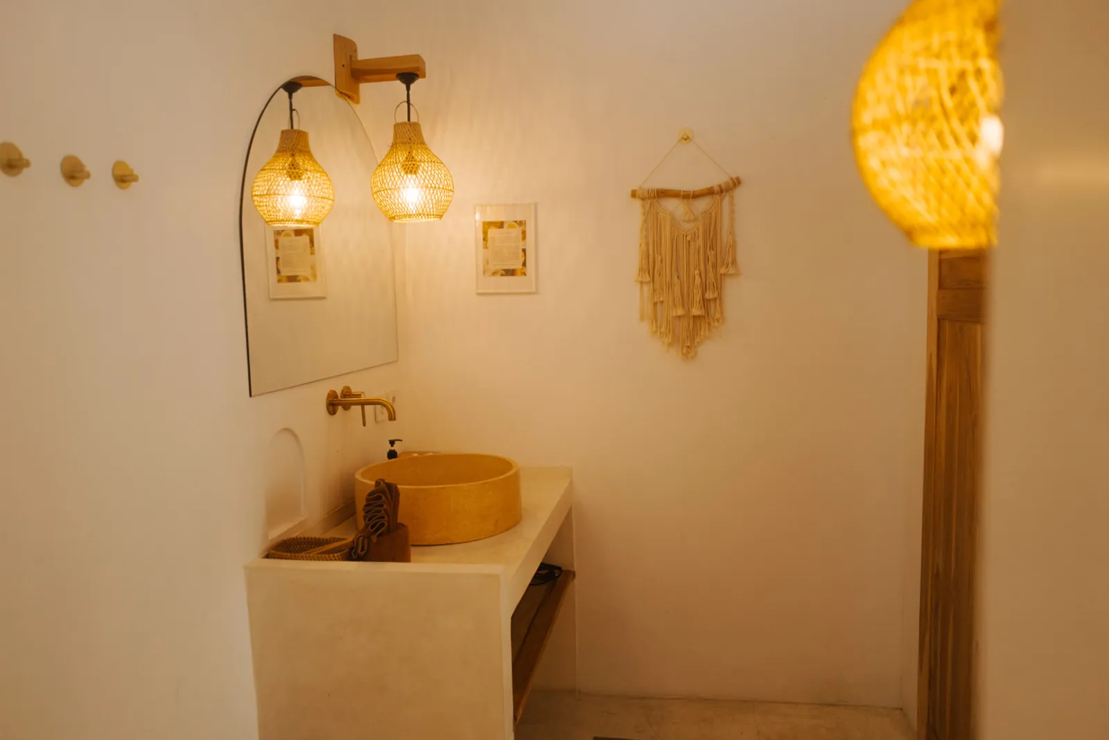 Stone basin and woven lamps in the Private Bungalow bathroom