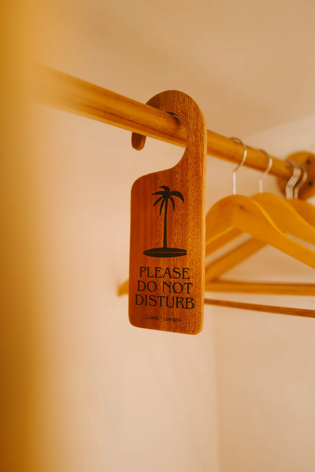 Wooden Luana Lombok do-not-disturb sign on a hanger rail