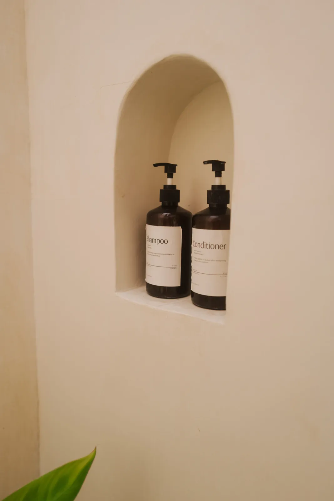 Refillable shampoo and conditioner in the Private Bungalow bathroom niche